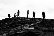 Black and white photos of the students taking photos on a rock formation