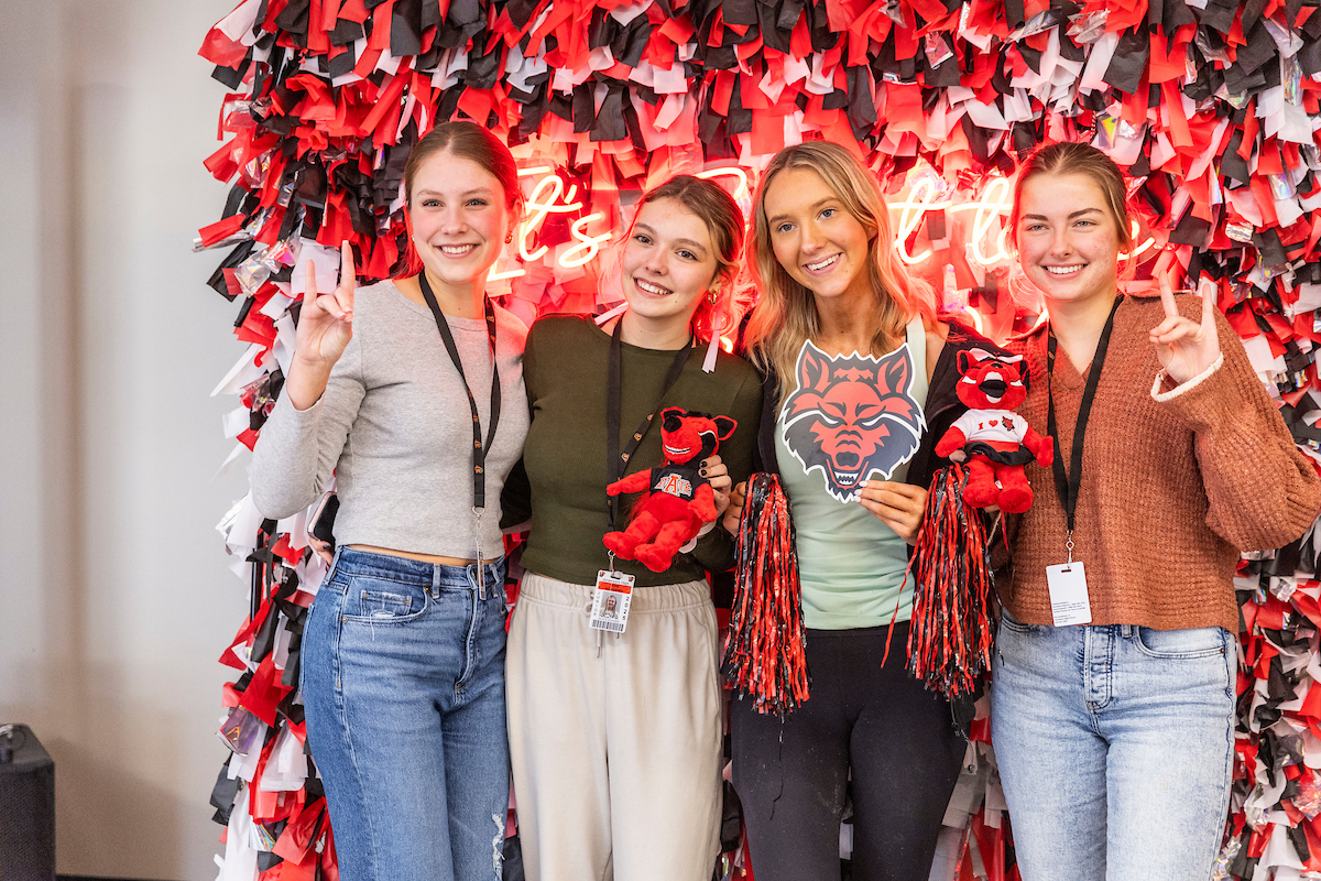 A group of high school students pose at an orientation event.