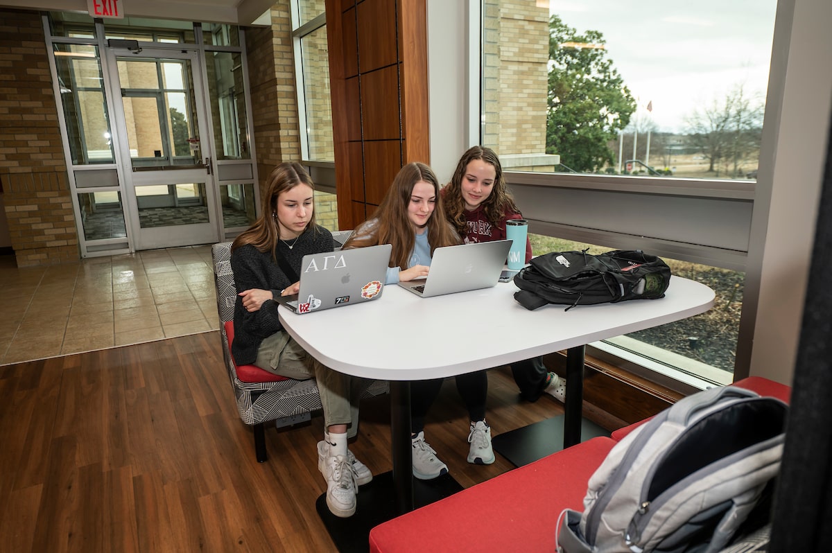 Students huddle around a laptop in one of A-State’s many study spaces