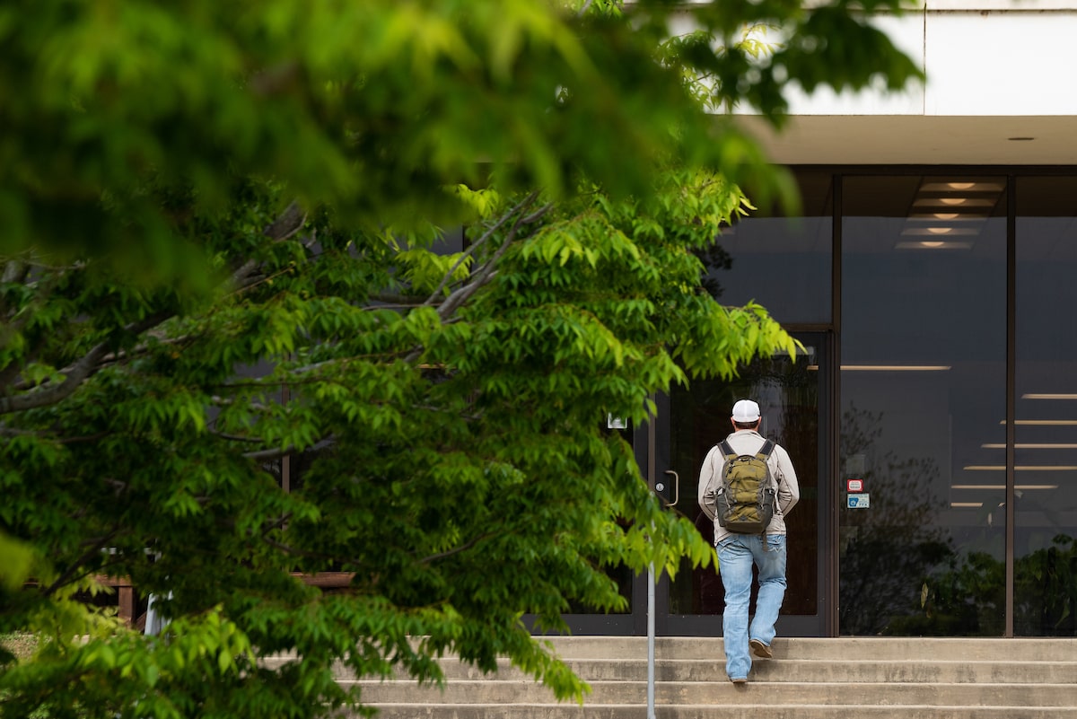 An A-State student enters an academic building for class.