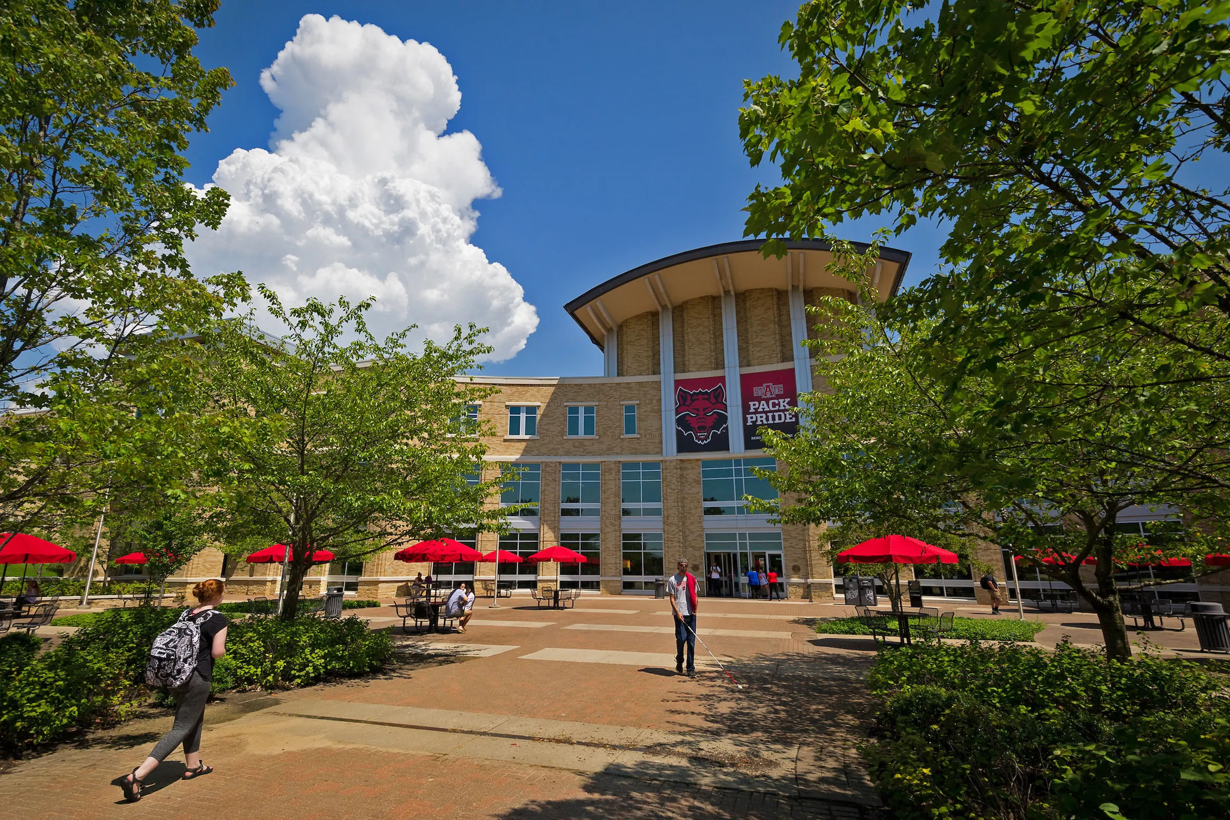 students walking with Reng Student Union in the background