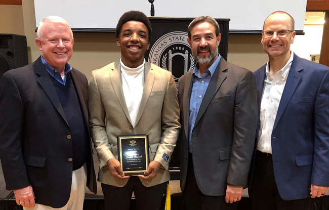 Joseph Branch (second from left) is congratulated on his internship award by Hytrol officials David Peacock, president, Ed Tanner, manager of process development, and Phillip Poston, director of strategic planning.