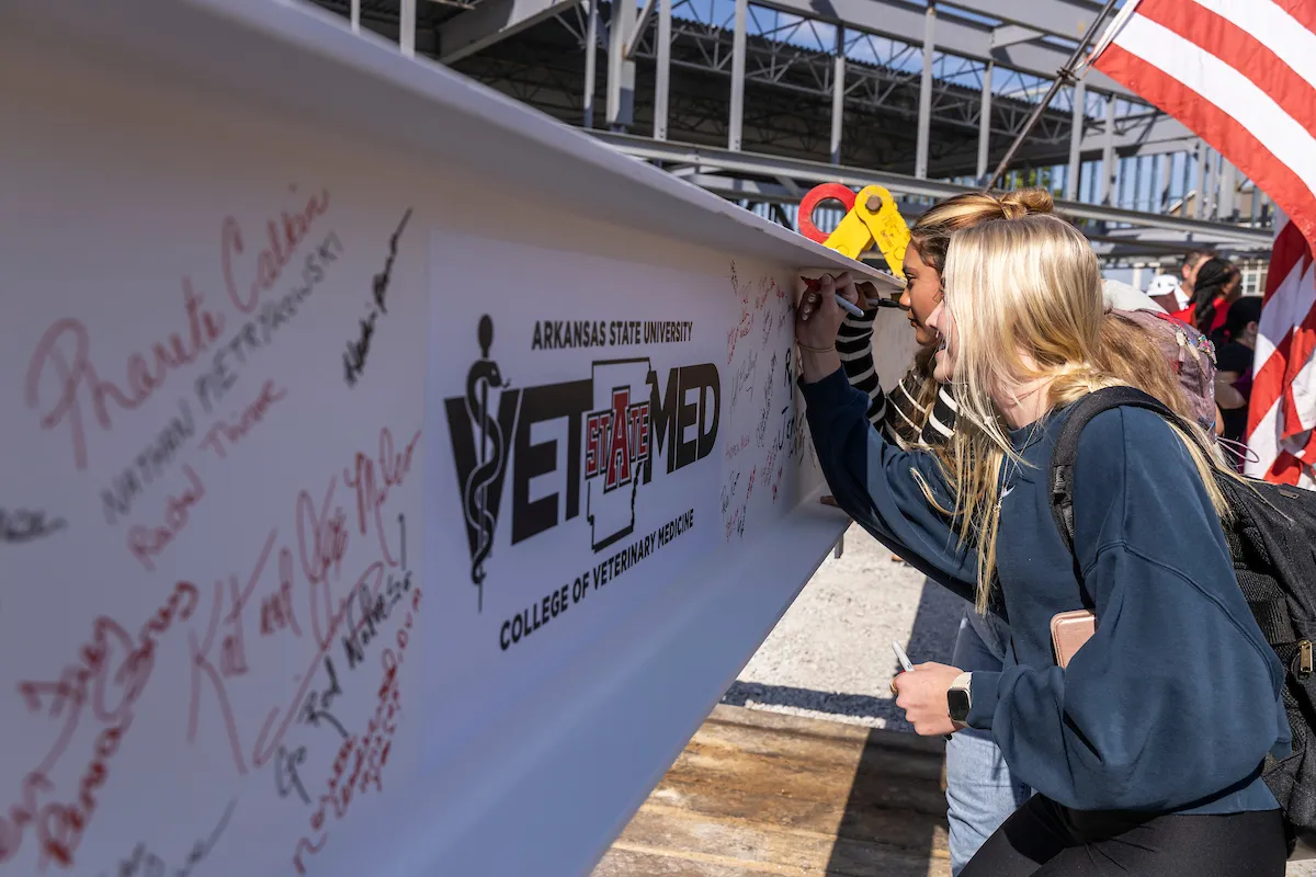 Pre-Vet Students sign the final beam of the CVM Building