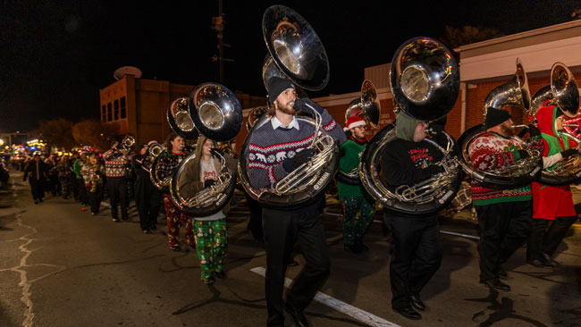 The Sound of the Natural State band marches in parade