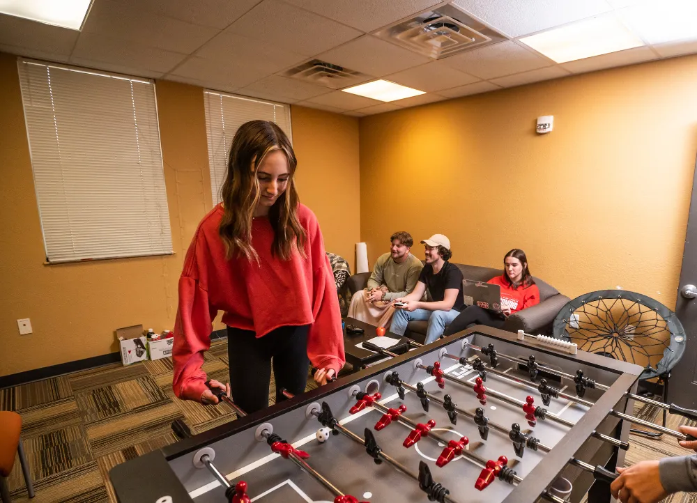 A-State students playing foozeball and video games.