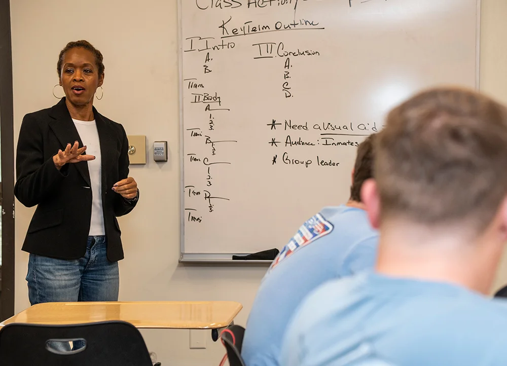 An A-State faculty speaking about a course schedule to the class.