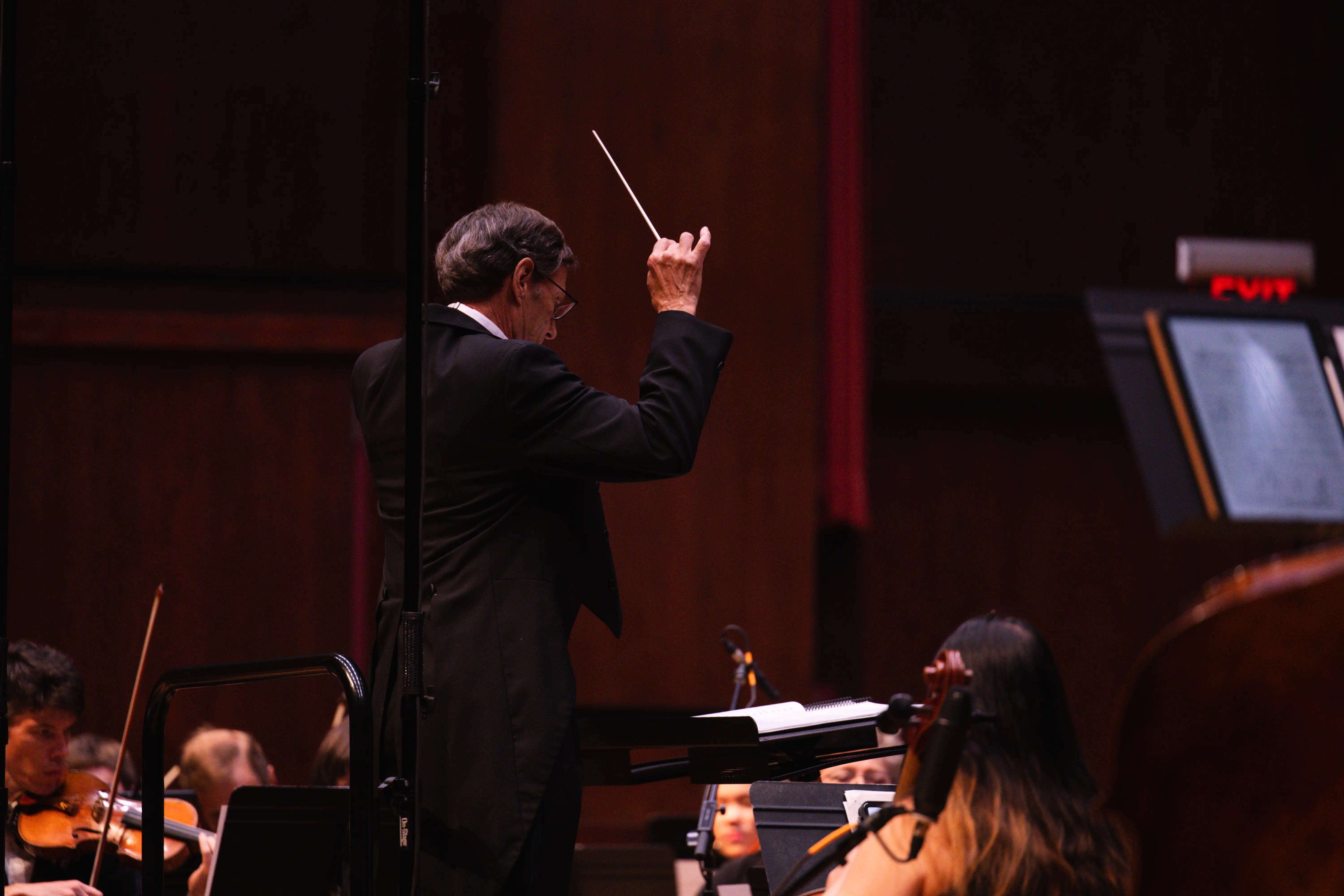 Conductor conducting orchestra.