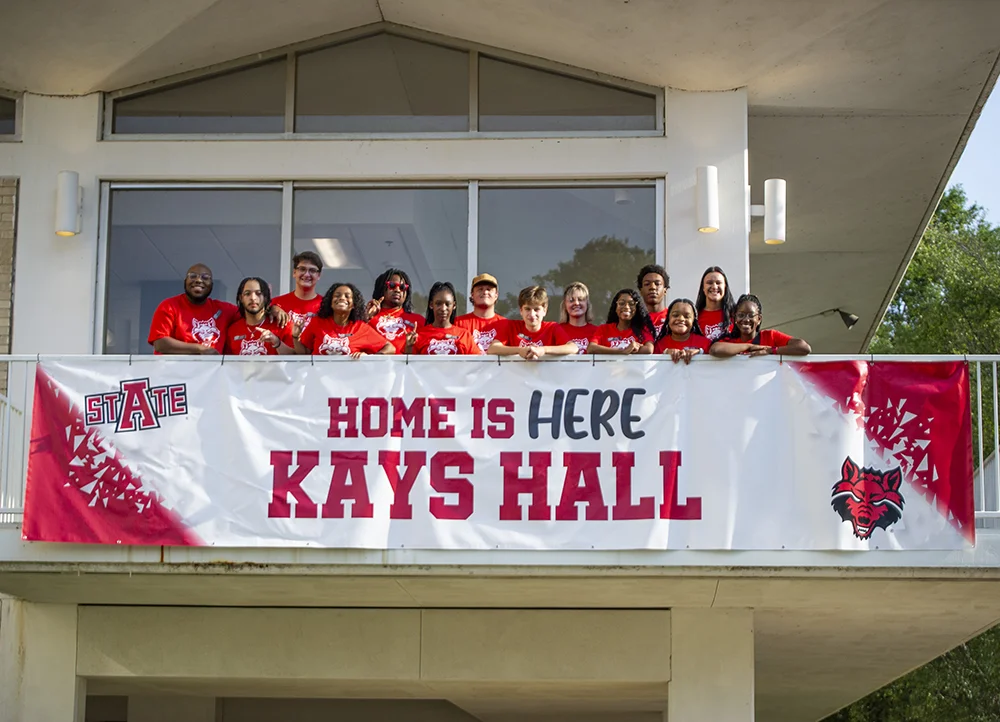 Students in front of banner for Kay's Hall