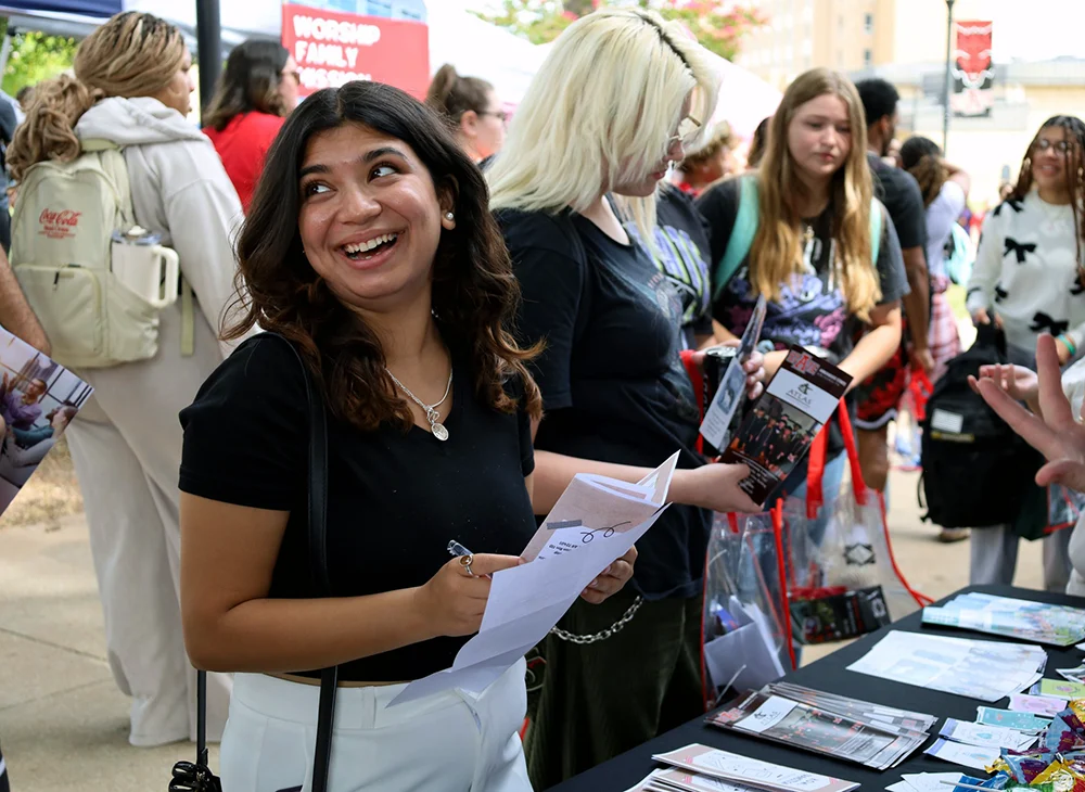 Student smiling at a H.O.W.L. event.
