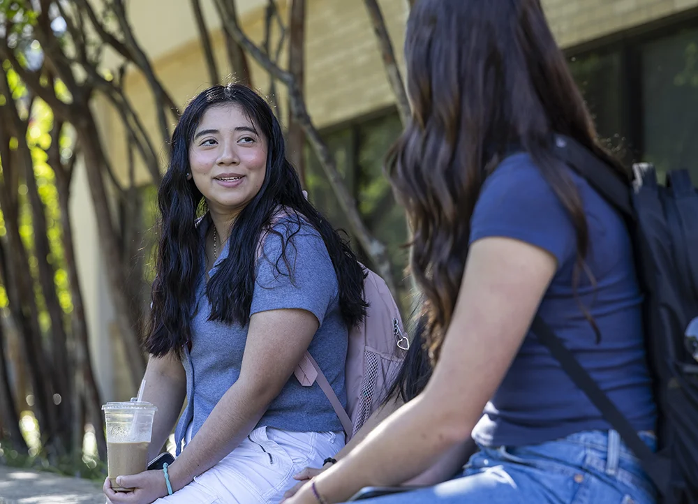 Two students talking on campus
