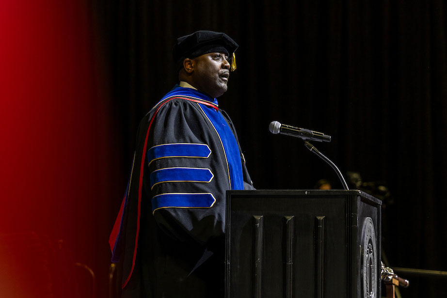 Dr. Calvin White addresses a crowd from the podium at a recent commencement.