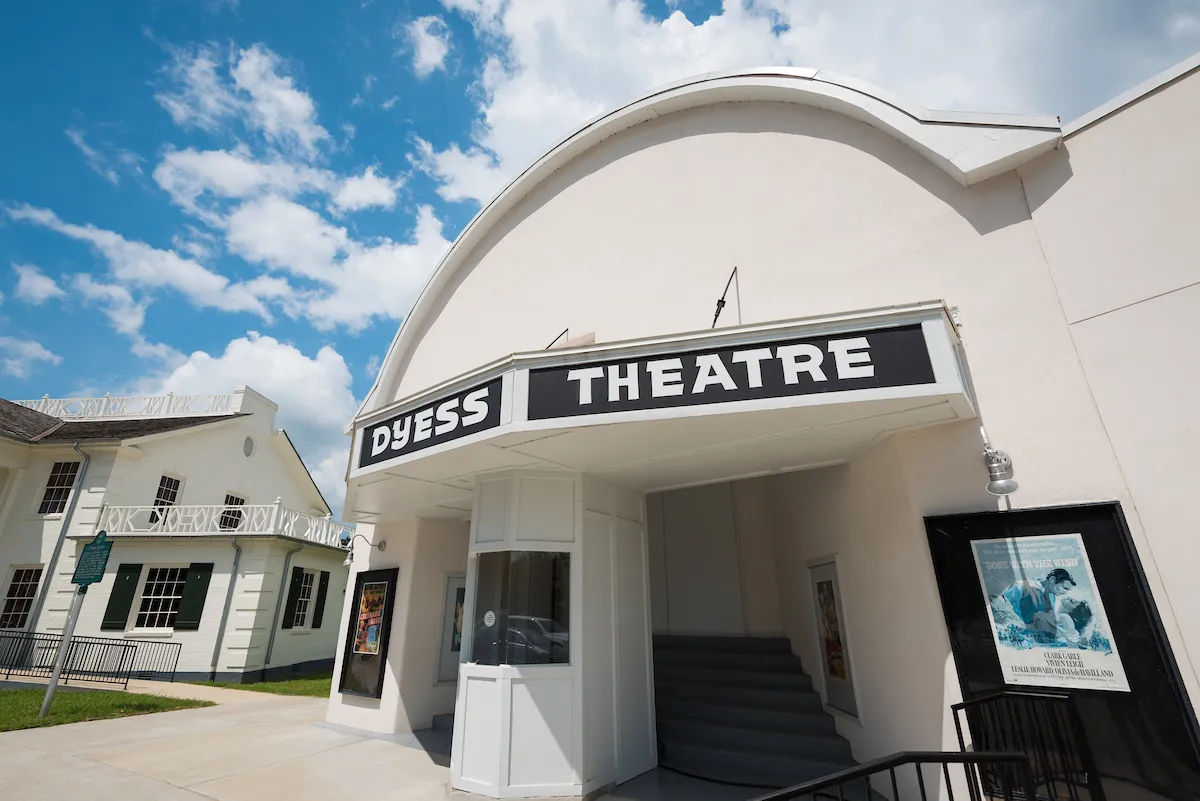Exterior view of Dyess Theatre under a sunny sky with adjacent historic buildings.