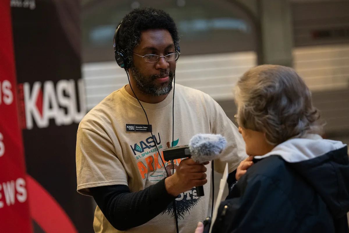 A KASU news reporter interviews attendees at an A-State campus event.