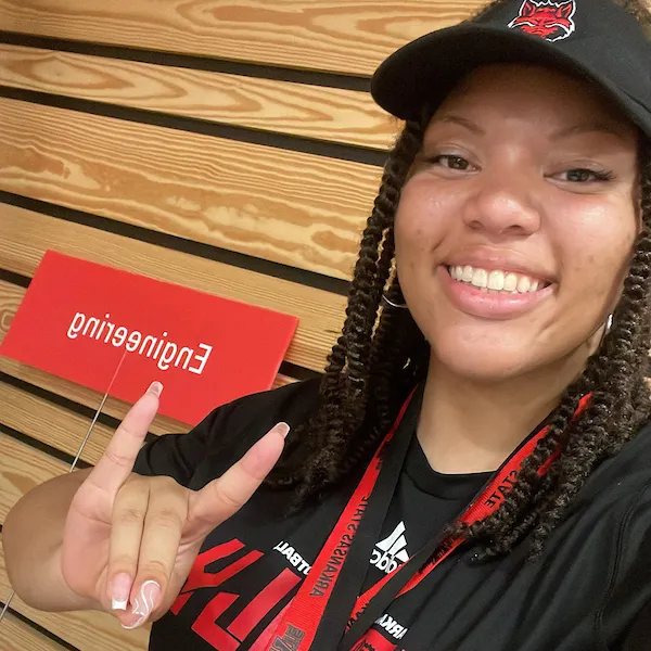 Kiria Flowers puts her Wolves Up in a selfie on campus.