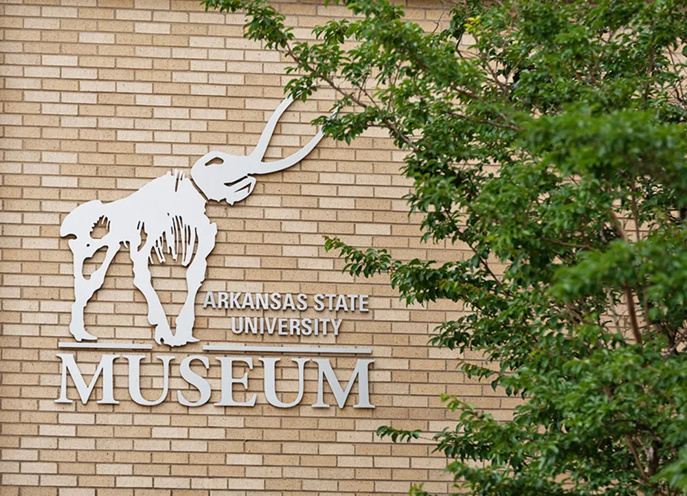 A-State Museum sign on side of the library building