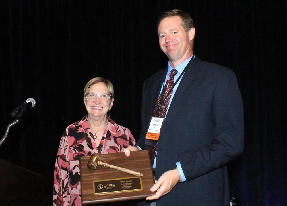 Associate Vice Chancellor for Facilities Brian Lasey accepts the gavel as president of the Central Association of Physical Plant Administrators at the organization’s annual conference in Lincoln, Neb.
