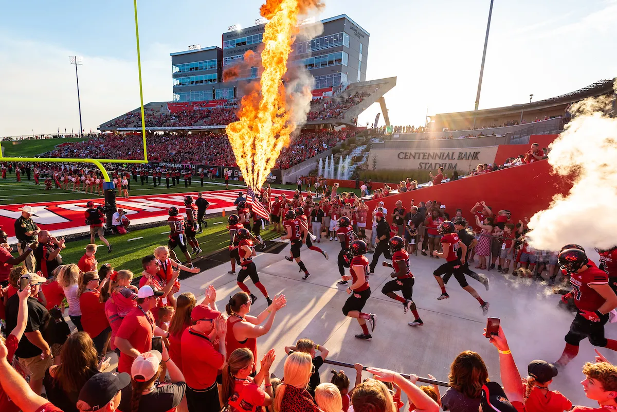 Red Wolves football team enters the stadium