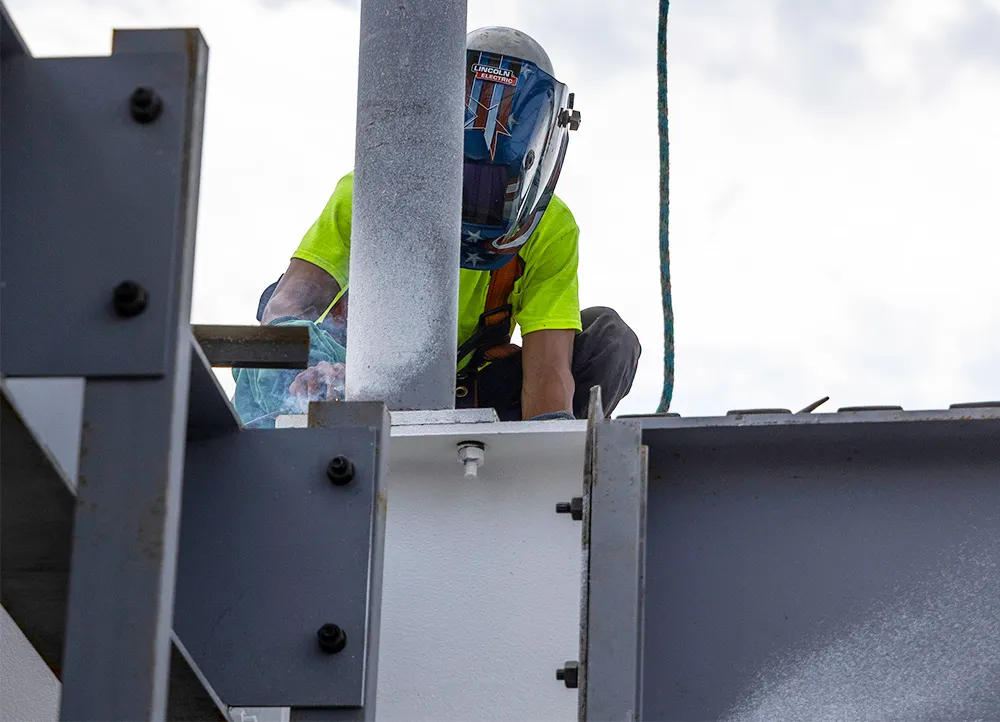 welder working with steel beams