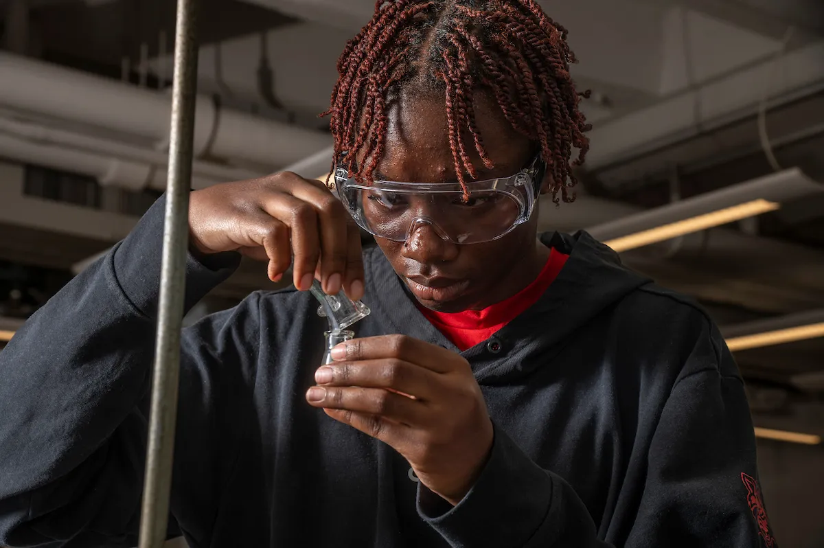 A student uses hand tools to take a measurement